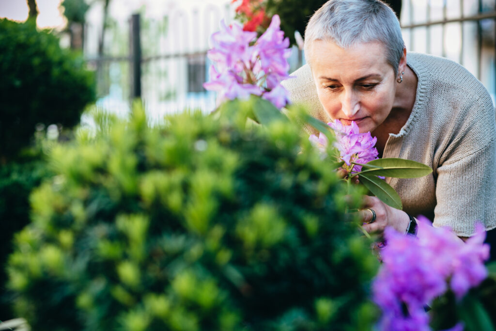 Woman in her 50s enjoying flowers